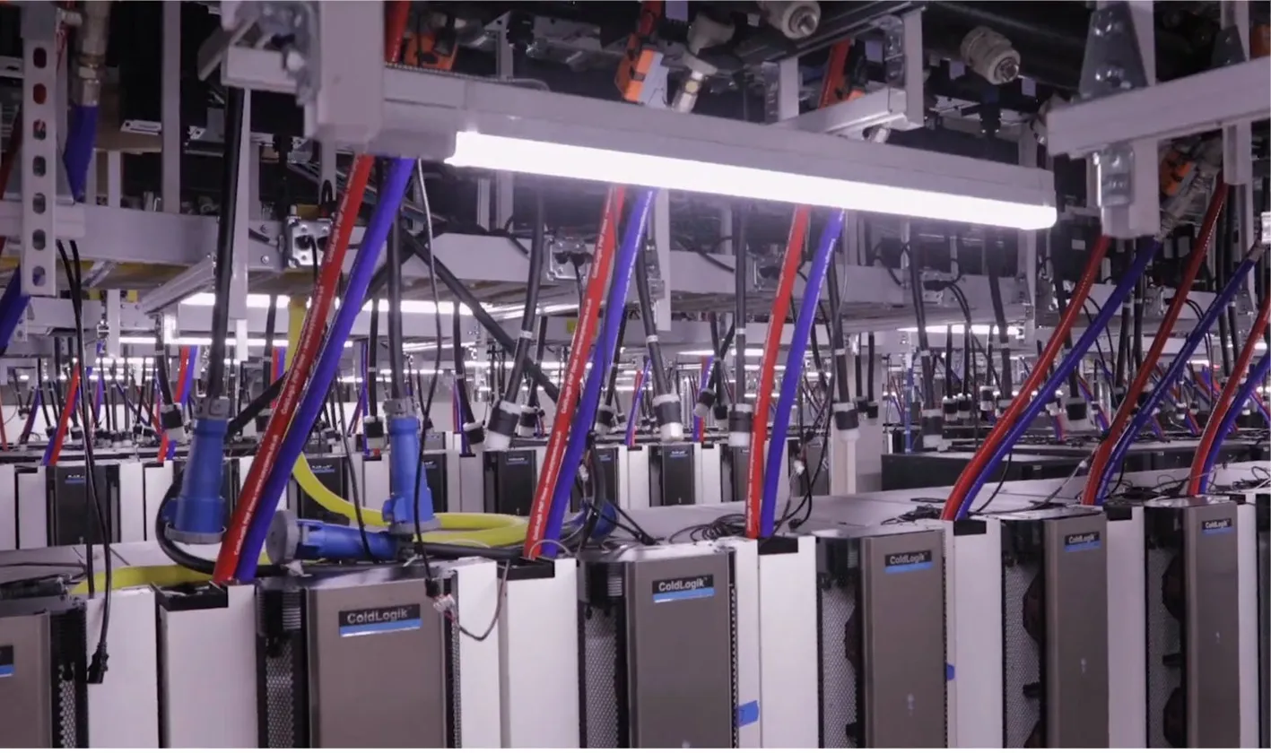 Rear-door heat exchangers and overhead coolant distribution in an operating AI data center